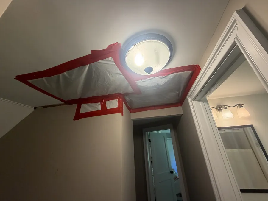 Protective sheeting and tape used to contain the hallway ceiling repair work area